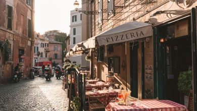 carriage and table on store front beside houses