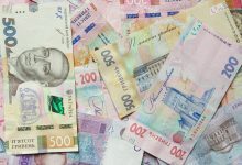 a pile of different bank notes laying on top of each other