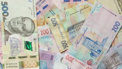 a pile of different bank notes laying on top of each other