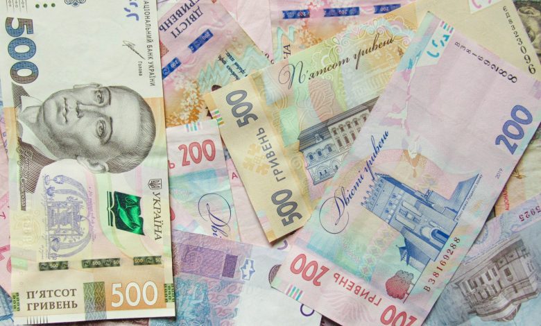 a pile of different bank notes laying on top of each other